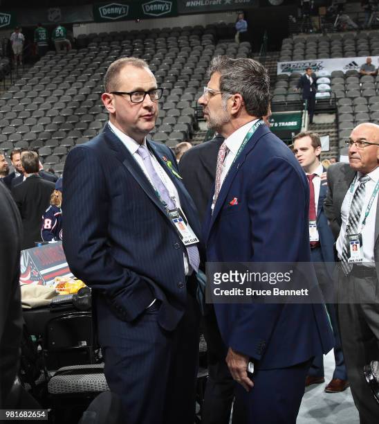 Brad Treliving of the Calgary Flames and Marc Bergevin of the Montreal Candiens chat prior to the first round of the 2018 NHL Draft at American...