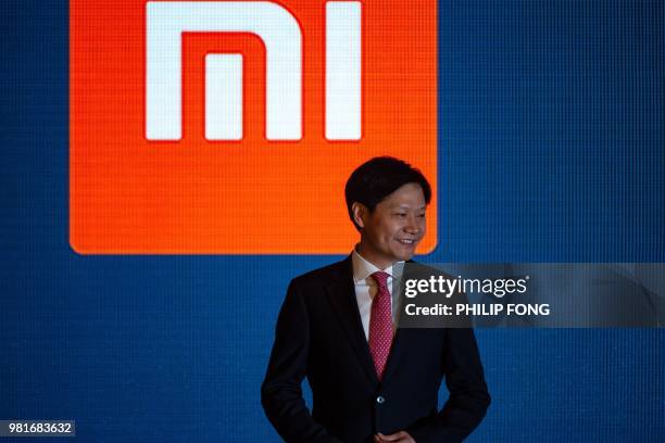 The CEO of Xiaomi Lei Jun speaks at the press conference following the company's initial public offering in Hong Kong on June 23, 2018. - China...