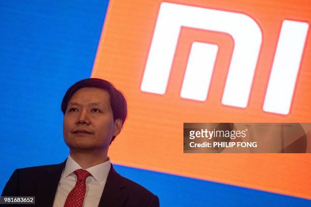 The CEO of Xiaomi Lei Jun speaks at the press conference following the company's initial public offering in Hong Kong on June 23, 2018. - China...