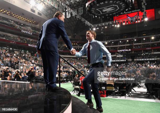 Alexander Alexeyev greets NHL commissioner Gary Bettman after being selected thirty-first overall by the Washington Capitals during the first round...