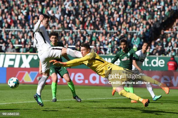 Bremen goalkeeper Jiri Pavlenka attempts to save during the German Bundesliga soccer match between Werder Bremen and Eintracht Frankfurt at...