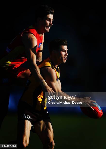 Alex Sexton of the Suns and Jaeger O'Meara of the Hawks compete for the ball during the round 14 AFL match between the Hawthorn Hawks and the Gold...