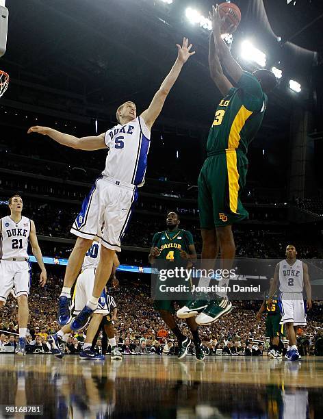 Mason Plumlee of the Duke Blue Devils looks tries to block a shot by Ekpe Udoh of the Baylor Bears during the south regional final of the 2010 NCAA...