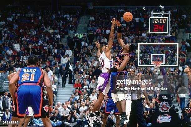 Marcus Camby of the Toronto Raptors battles for the jump ball against Patrick Ewing of the New York Knicks during Game Three of the 2000 Eastern...