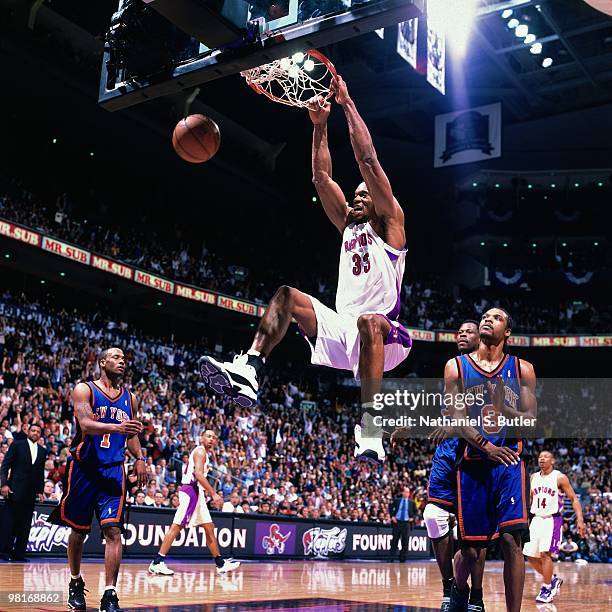 Antonio Davis of the Toronto Raptors dunks against Latrell Sprewell of the New York Knicks during Game Three of the 2000 Eastern Conference...