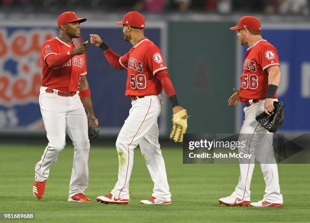 Justin Upton, Michael Hermosillo and Kole Calhoun of the Los Angeles Angels of Anaheim celebrate a 2-1 win over Toronto Blue Jays at Angel Stadium on...