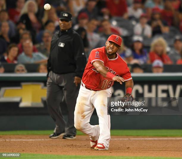 Luis Valbuena of the Los Angeles Angels of Anaheim makes a throw to first base to catch Randal Grichuk of the Toronto Blue Jays in the seventh inning...