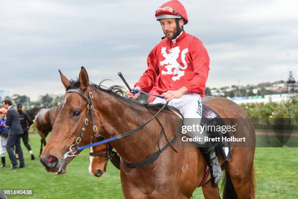 Damien Oliver returns to the mounting yard on Remember the Name after winning the Macedon and Goldfields Handicap at Flemington Racecourse on June...