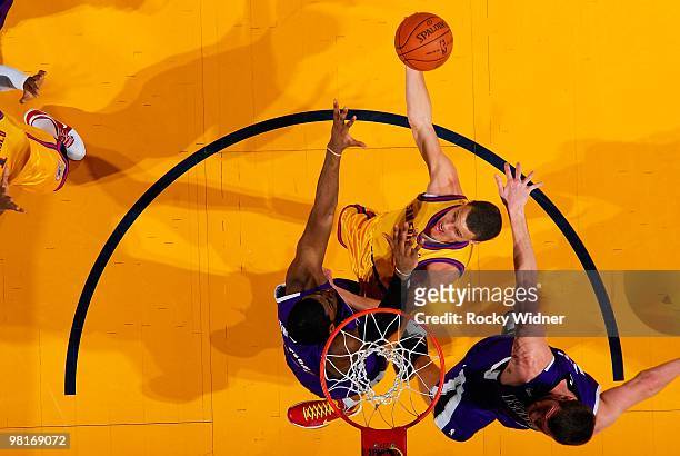 Stephen Curry of the Golden State Warriors goes to the basket against Jason Thompson and Spencer Hawes of the Sacramento Kings during the game on...