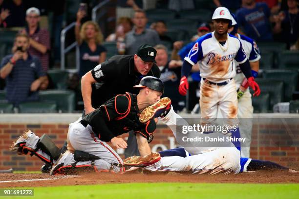 Freddie Freeman of the Atlanta Braves is tagged out at home by Caleb Joseph of the Baltimore Orioles during the ninth inning at SunTrust Park on June...