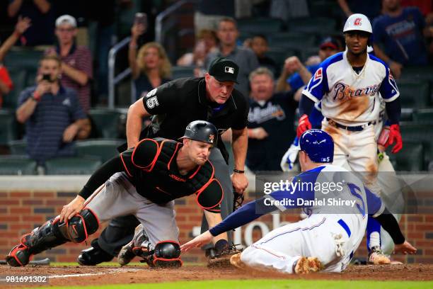 Freddie Freeman of the Atlanta Braves is tagged out at home by Caleb Joseph of the Baltimore Orioles during the ninth inning at SunTrust Park on June...