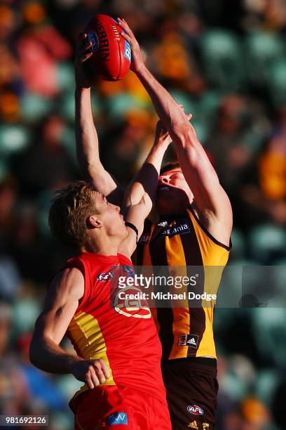 Tim O'Brien of the Hawks marks the ball against Tom Lynch of the Suns during the round 14 AFL match between the Hawthorn Hawks and the Gold Coast...