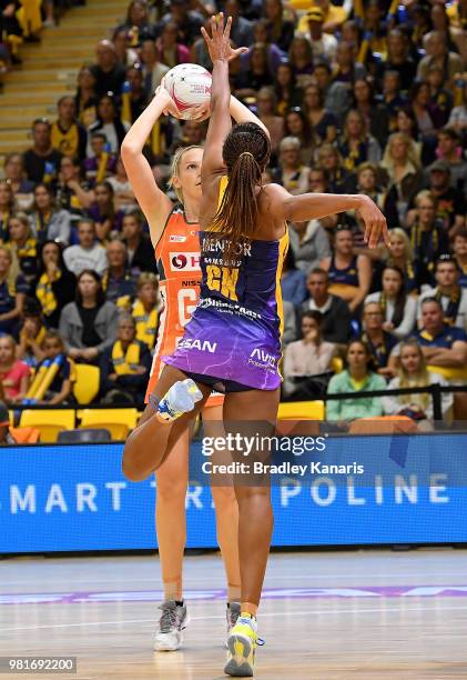 Joanne Harten of the Giants is pressured by the defence of Geva Mentor of the Lightning during the round eight Super Netball match between the...