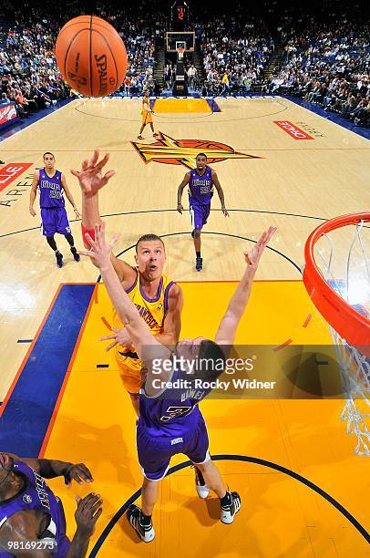 Andris Biedrins of the Golden State Warriors puts a shot up over Spencer Hawes of the Sacramento Kings during the game on February 17, 2009 at Oracle...