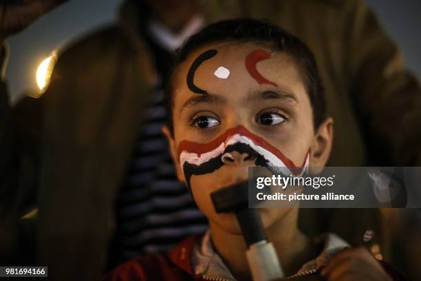 Dpatop - A girl blows into a vuvuzela during celebrations after the re-election of Egyptian President Abdel-Fattah al-Sisi for a second four-year...