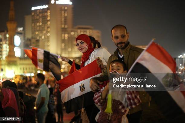 Dpatop - People wave flags of Egypt during celebrations after the re-election of Egyptian President Abdel-Fattah al-Sisi for a second four-year term,...