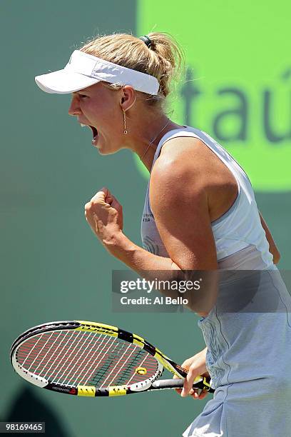 Caroline Wozniacki of Denmark reacts after winning the first set against Justine Henin of Belgium during day nine of the 2010 Sony Ericsson Open at...