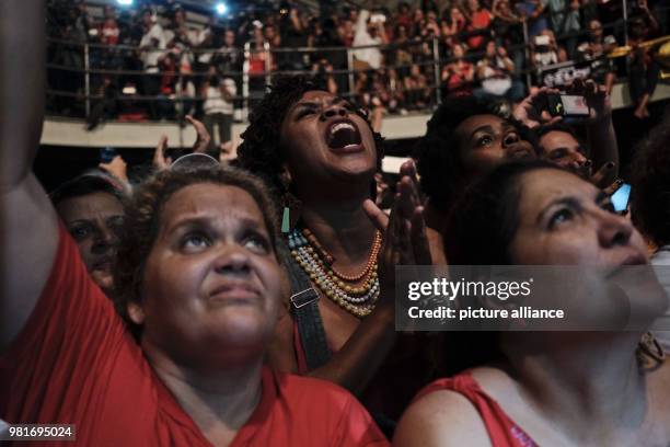 Supporters of Brazil's Former president, Luiz Inacio Lula da Silva, listen to his address at a campaign rally organized by left-wing political...