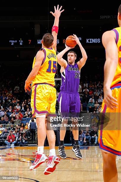 Spencer Hawes of the Sacramento Kings shoots over Andris Biedrins of the Golden State Warriors during the game on February 17, 2009 at Oracle Arena...