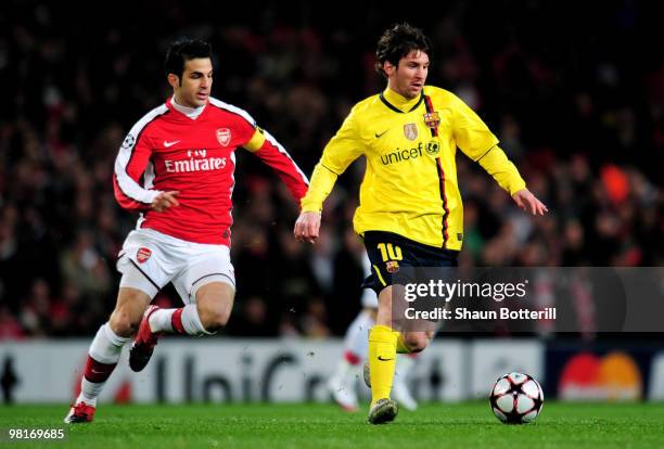 Lionel Messi of Barcelona is pursued by Cesc Fabregas of Arsenal during the UEFA Champions League quarter final first leg match between Arsenal and...