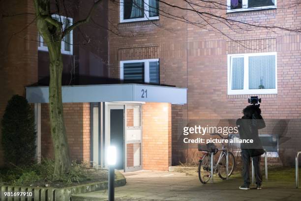 March 2018, Germany, Hannover: A cameraman in front of an apartment house in the district Gross-Buchholz, where two dead people were found. Those...