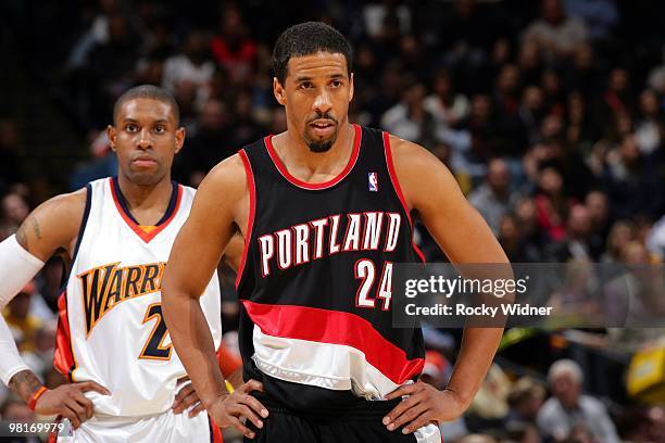 Andre Miller of the Portland Trail Blazers and C.J. Watson of the Golden State Warriors stand on the court during the game at Oracle Arena on March...