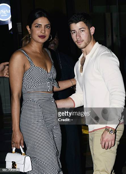 Indian Bollywood actress Priyanka Chopra and US singer Nick Jonas stand together in Mumbai on June 22, 2018. -