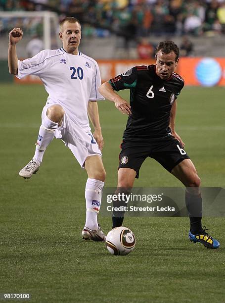 Gerardo Torrado of Mexico goes for a ball against Orn Gunnar Jonsson of Iceland at Bank of America Stadium on March 24, 2010 in Charlotte, North...