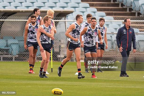 Rory Sloane of the Crows, Curly Hampton of the Crows and Adelaide Crows Senior Coach Don Pyke look on during a training session prior to a press...