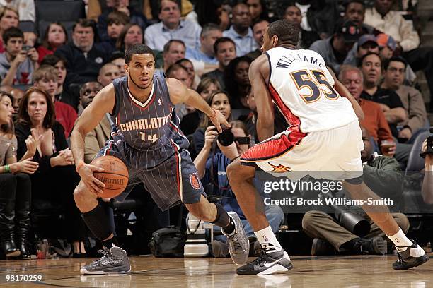 Augustin of the Charlotte Bobcats looks to make a move against Reggie Williams of the Golden State Warriors during the game at Time Warner Cable...