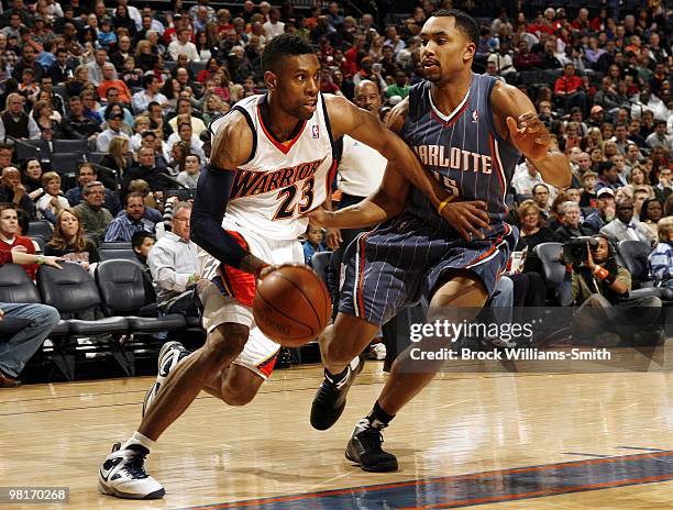 Watson of the Golden State Warriors drives to the basket against Gerald Henderson of the Charlotte Bobcats during the game at Time Warner Cable Arena...