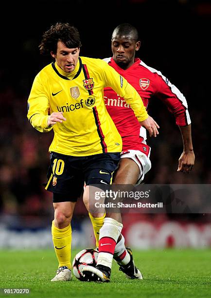 Lionel Messi of Barcelona is tackled by Abou Diaby of Arsenal during the UEFA Champions League quarter final first leg match between Arsenal and FC...