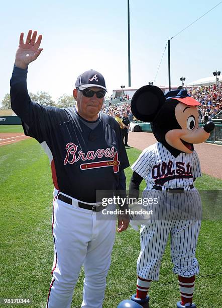 In this handout photo provided by Disney, With Mickey Mouse at his side, Atlanta Braves manager Bobby Cox acknowledges the crowd at ESPN Wide World...