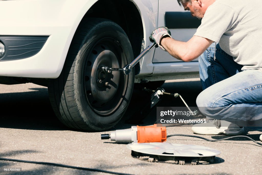 Man changing car tire