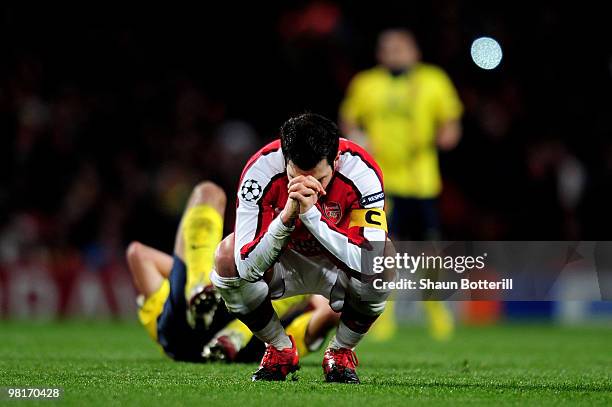 Cesc Fabregas of Arsenal reacts after being shown a yellow card by referee Massimo Busacca of Switerland during the UEFA Champions League quarter...