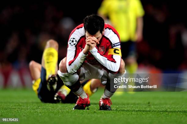 Cesc Fabregas of Arsenal reacts after being shown a yellow card by referee Massimo Busacca of Switerland during the UEFA Champions League quarter...