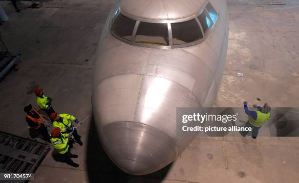 April 2018, Germany, Dresden: The hull of the aircraft 152 being transferred in a hangar of the Dresden International Airport. The Baade 152 was the...