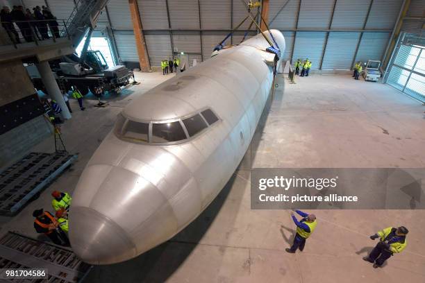 April 2018, Germany, Dresden: The hull of the aircraft 152 being transferred in a hangar of the Dresden International Airport. The Baade 152 was the...