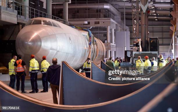 April 2018, Germany, Dresden: The hull of the aircraft 152 being transferred in a hangar of the Dresden International Airport. The Baade 152 was the...