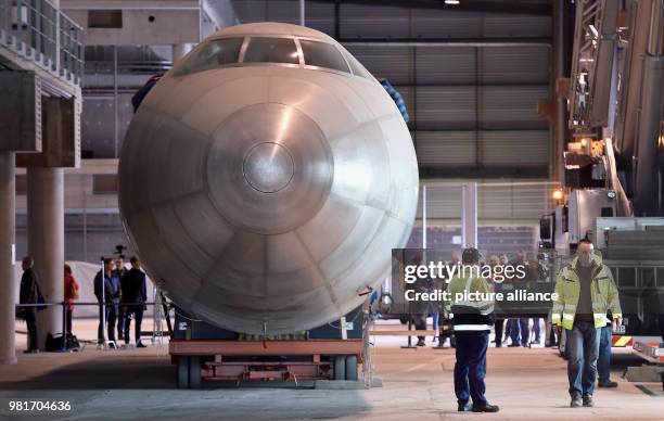 April 2018, Germany, Dresden: The hull of the aircraft 152 being transferred in a hangar of the Dresden International Airport. The Baade 152 was the...