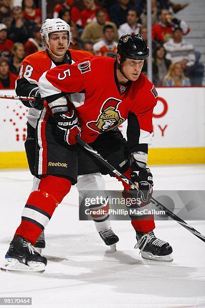 Andy Sutton of the Ottawa Senators is defended by Daniel Briere of the Philadelphia Flyers during their NHL game at Scotiabank Place on March 23,...