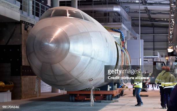 April 2018, Germany, Dresden: The hull of the aircraft 152 being transferred in a hangar of the Dresden International Airport. The Baade 152 was the...