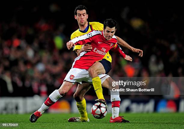 Cesc Fabregas of Arsenal is tackled by Sergio Busquets of Barcelona during the UEFA Champions League quarter final first leg match between Arsenal...