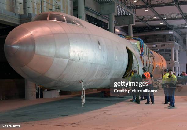 April 2018, Germany, Dresden: The hull of the aircraft 152 being transferred in a hangar of the Dresden International Airport. The Baade 152 was the...