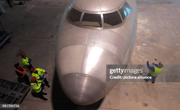 Dpatop - 04 April 2018, Germany, Dresden: The hull of the aircraft 152 being transferred in a hangar of the Dresden International Airport. The Baade...