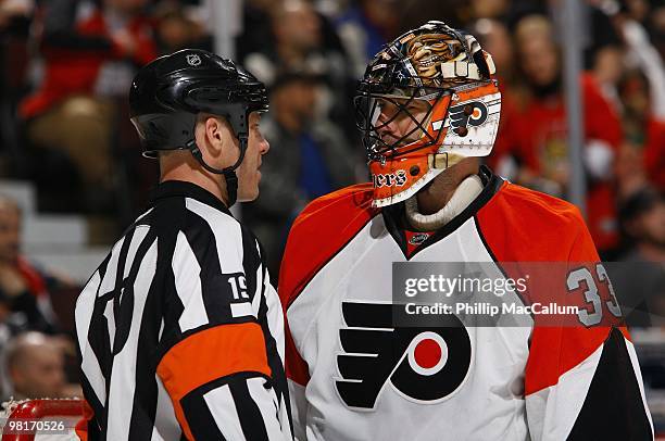 Goaltender Brian Boucher of the Philadelphia Flyers talks with referee Gord Dwyer during the NHL game against the Ottawa Senators at Scotiabank Place...