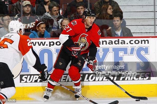 Alex Kovalev of the Ottawa Senators looks to pass while being defended by Matt Carle of the Philadelphia Flyers during their NHL game at Scotiabank...