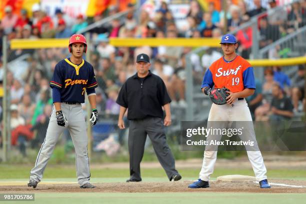 Kyle Knell of the Alaska Goldpanners takes a lead off first base as Tyler Dean of the Orange County Surf stands on defense during the 113th Midnight...