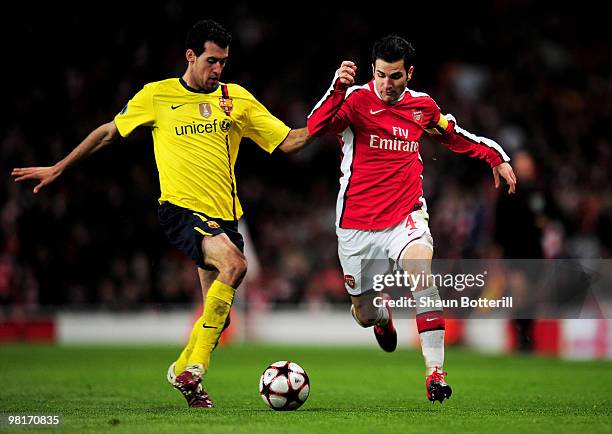 Cesc Fabregas of Arsenal battles for the ball with Sergio Busquets of Barcelona during the UEFA Champions League quarter final first leg match...