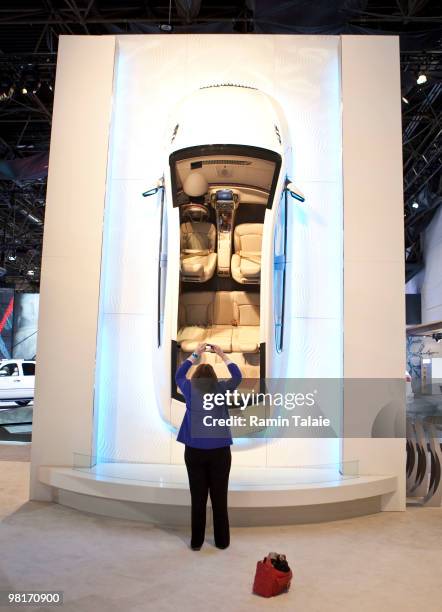 Woman photographs a car display during the New York Auto International Show March 31, 2010 in New York City. Over 1 million visitors are expected to...